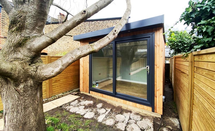 Small garden office at the bottom of small urban garden