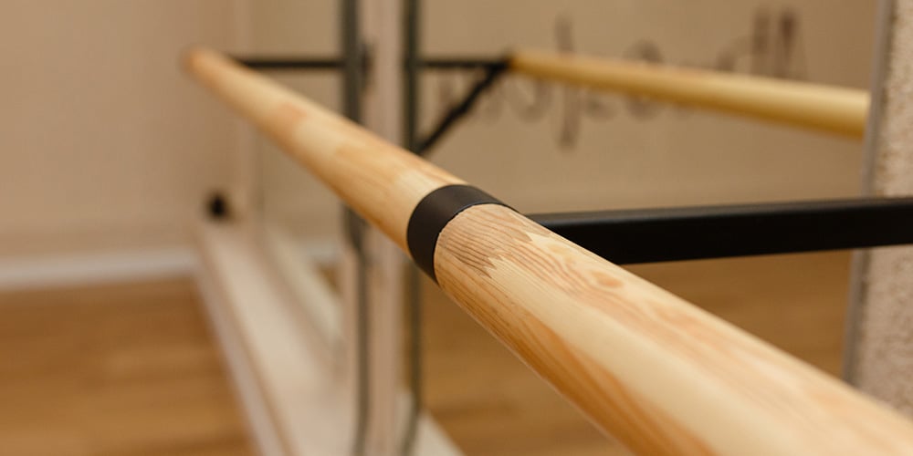 Inside a dance studio with barre set up for practising