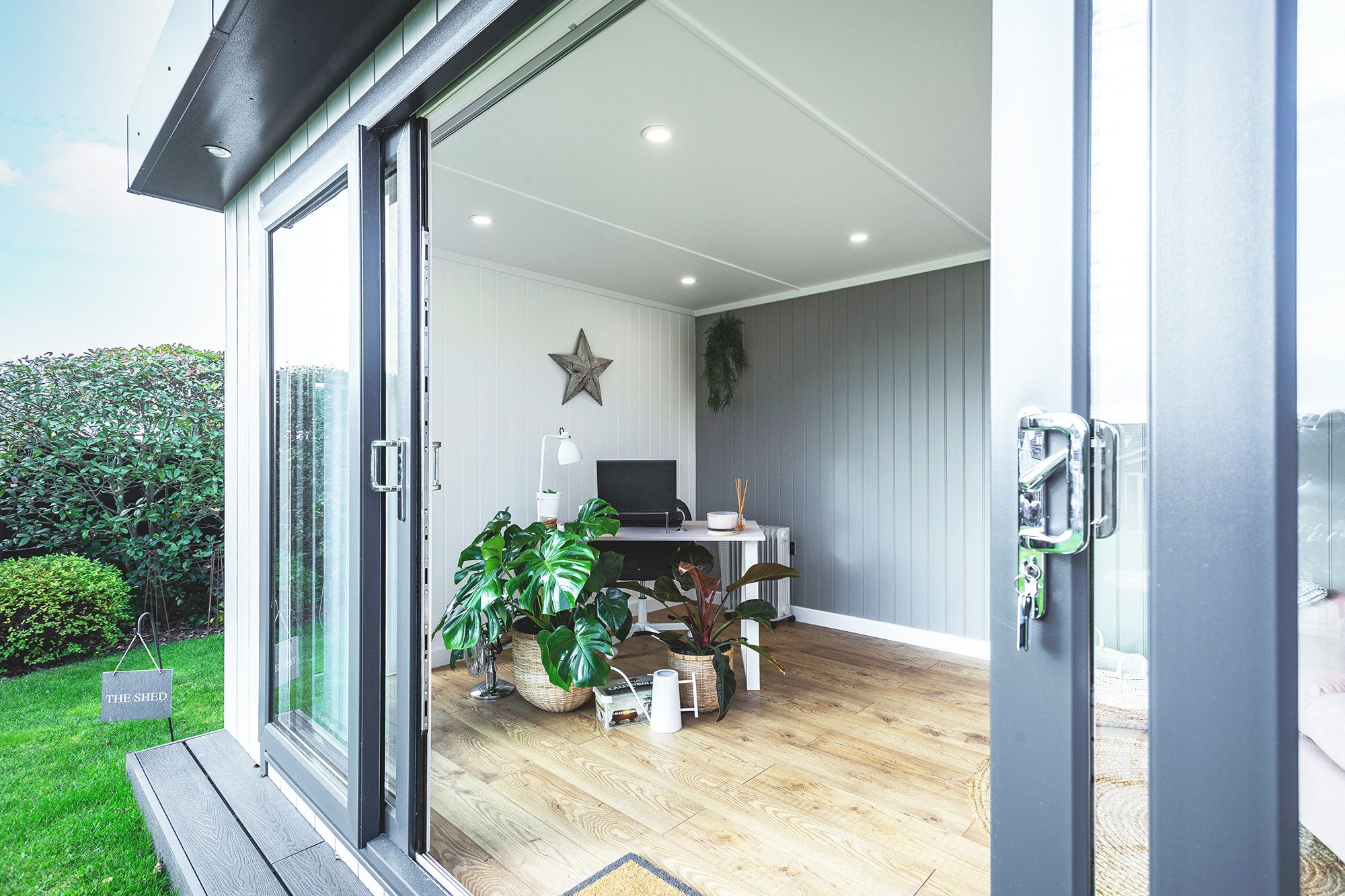 Looking into a Garden Office pod with sliding doors open so you can see the desk area