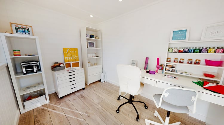 Interior of a garden office craft room with white furniture