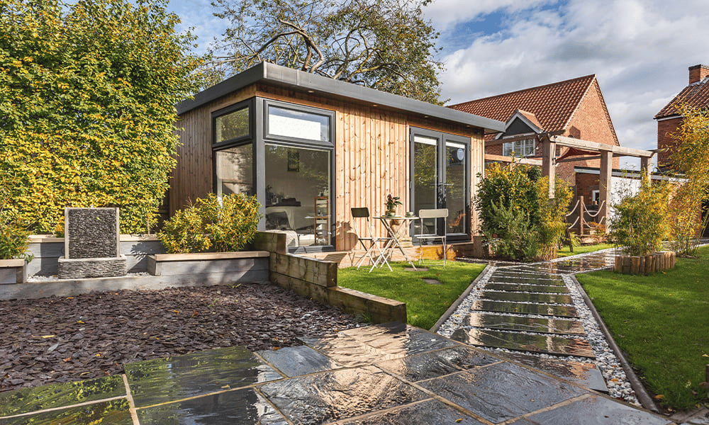 Cabin Master Redwood Beauty Studio with patio steps and lawn area with tables and chairs
