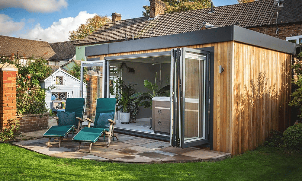Large Hot Tub Room with open bifold doors and patio area with 2 deck chairs on it