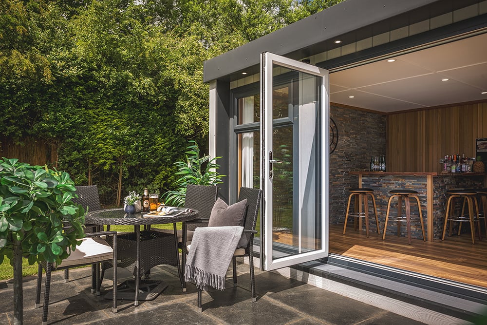 Exterior of a large garden bar man cave with seating outside