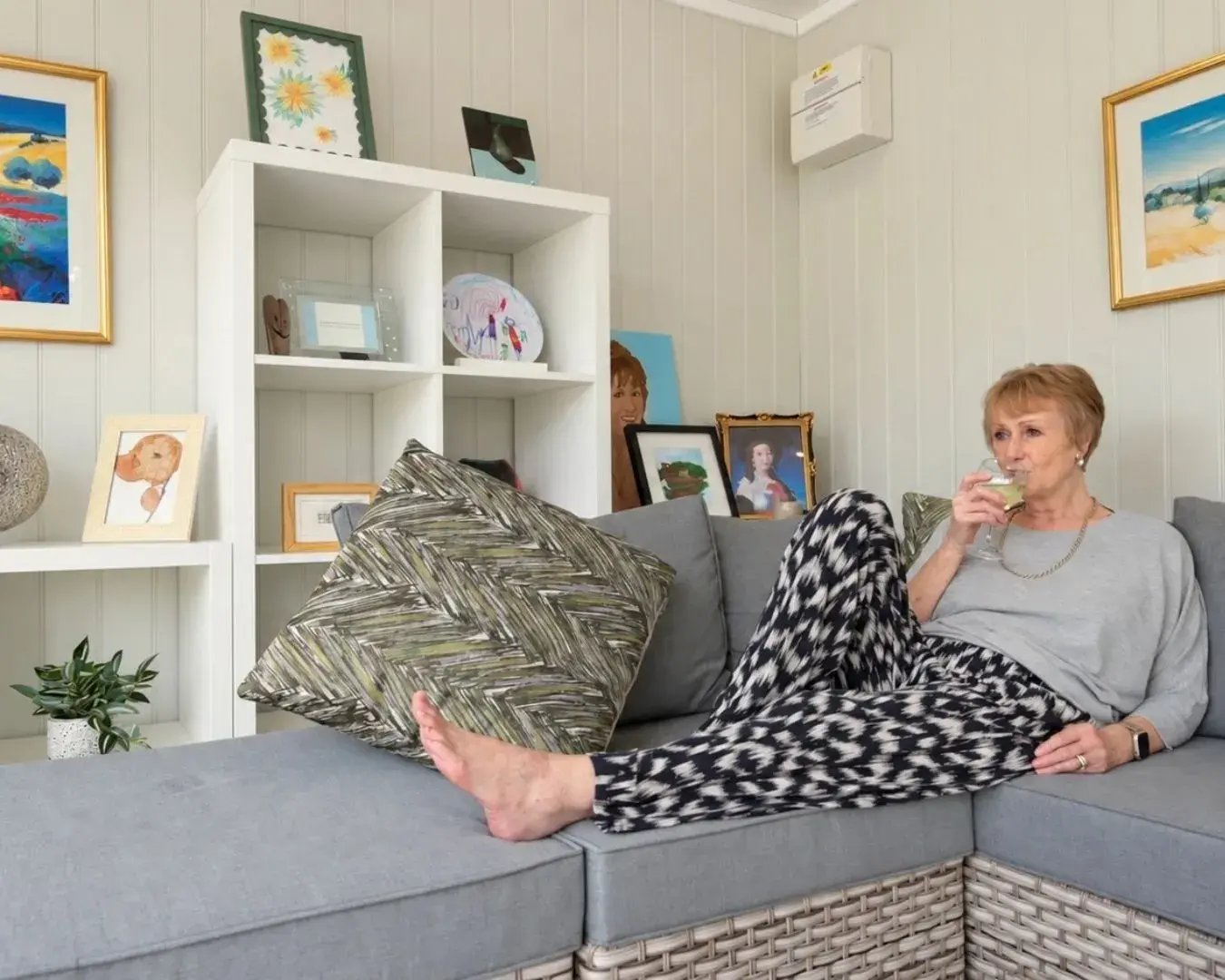 woman relaxing on sofa in garden summer house