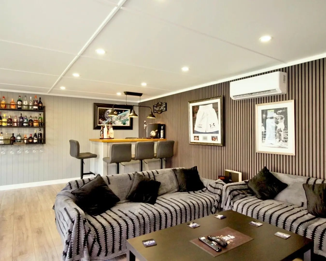 Large bespoke games room featuring a home bar, pool table and comfortable lounge area.