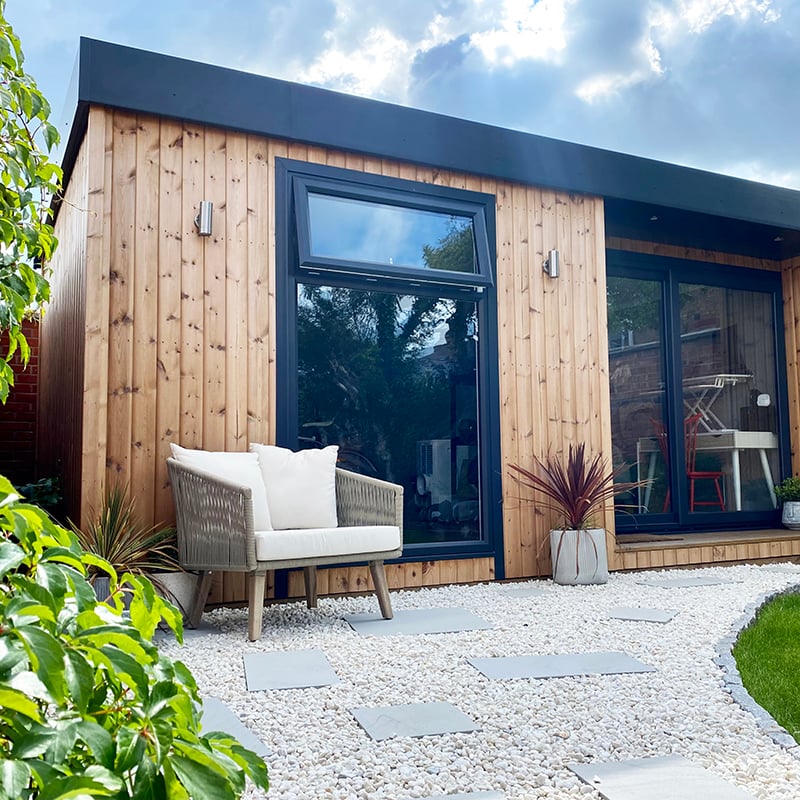 Cedar Small Garden Office Pod with timber decking and grass lawn in foreground