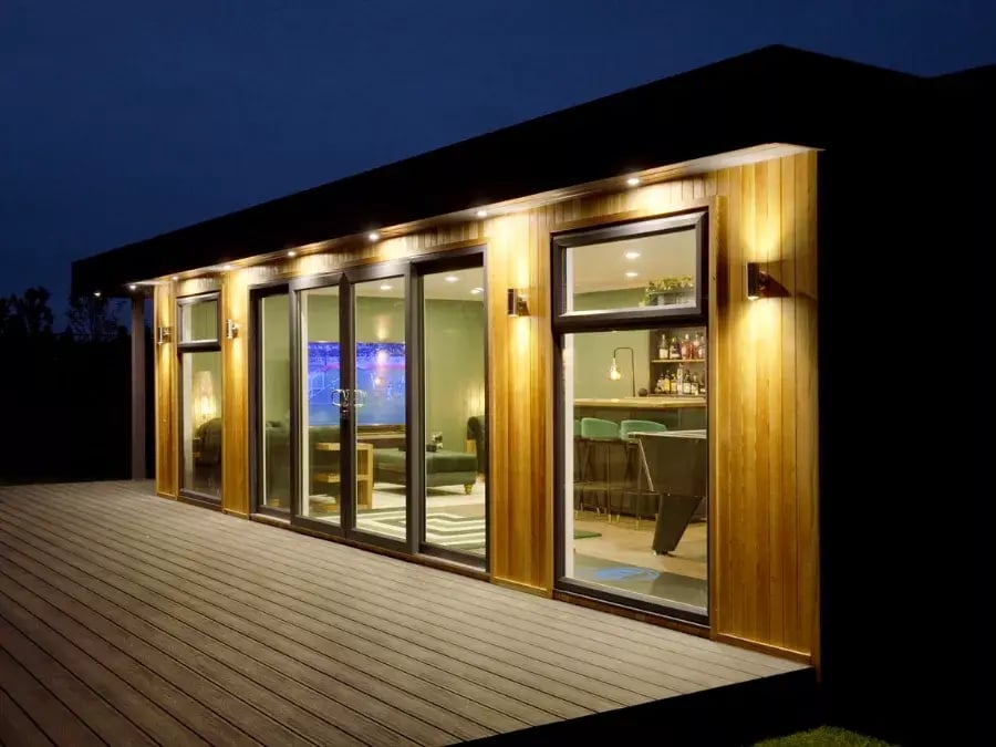 garden man cave lit up with external lighting at night