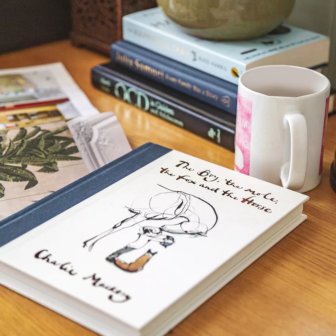 Garden Office Pod Building with zoom in on book and mug of coffee