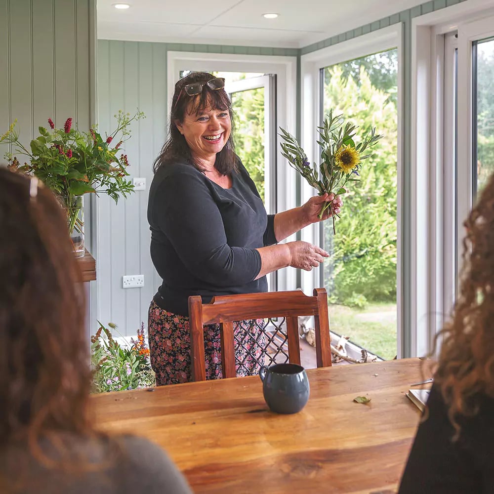 floristry workshop taking place within a garden studio