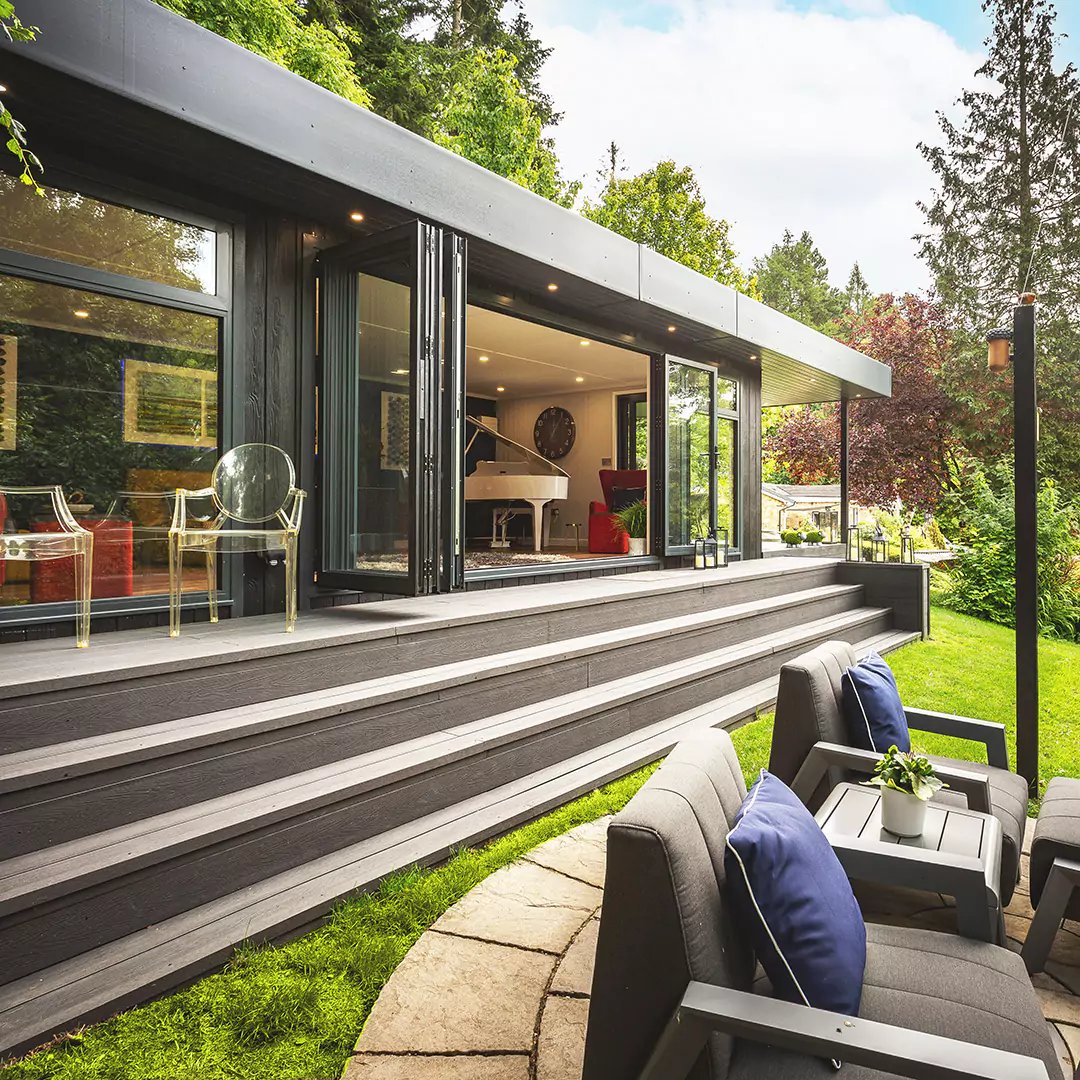 large impressive composite garden room with steps and decking