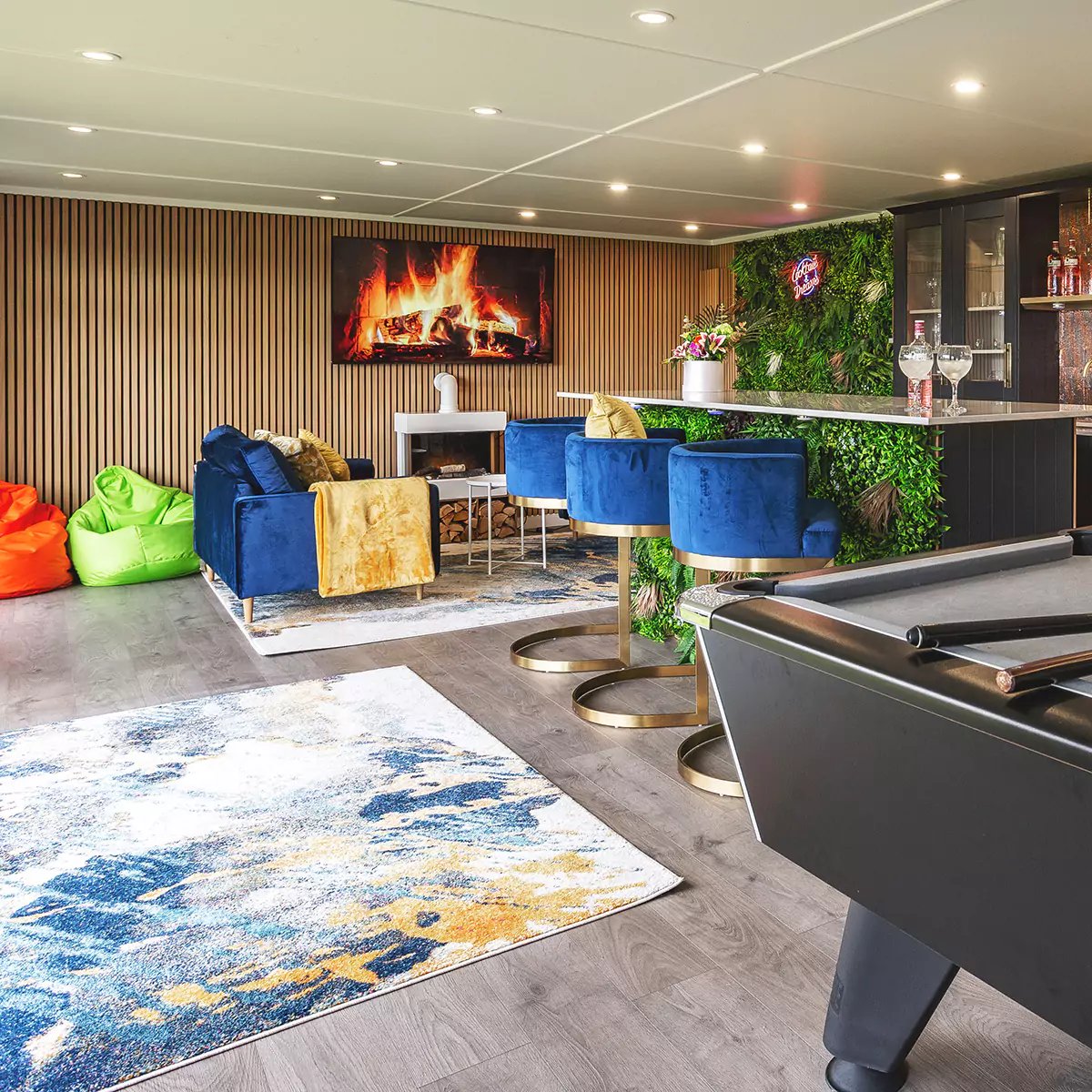 a garden bar with a blue velvet chair and a yellow pillow sitting on top of it
