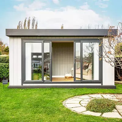 Looking into a bespoke garden office, desk and laptop can be seen