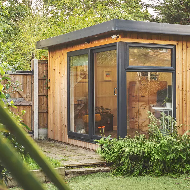 Corner Redwood Garden Office with view of green lawn