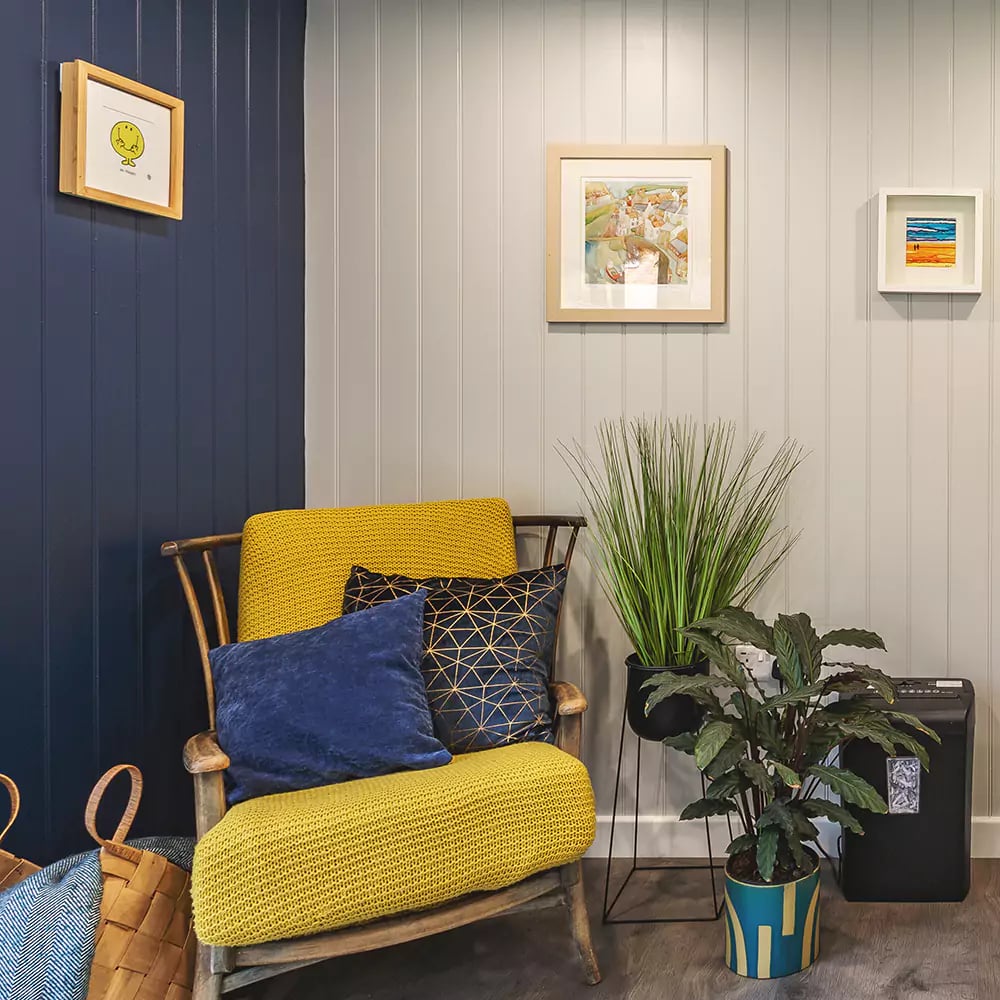 interior of a small garden office with navy blue feature wall
