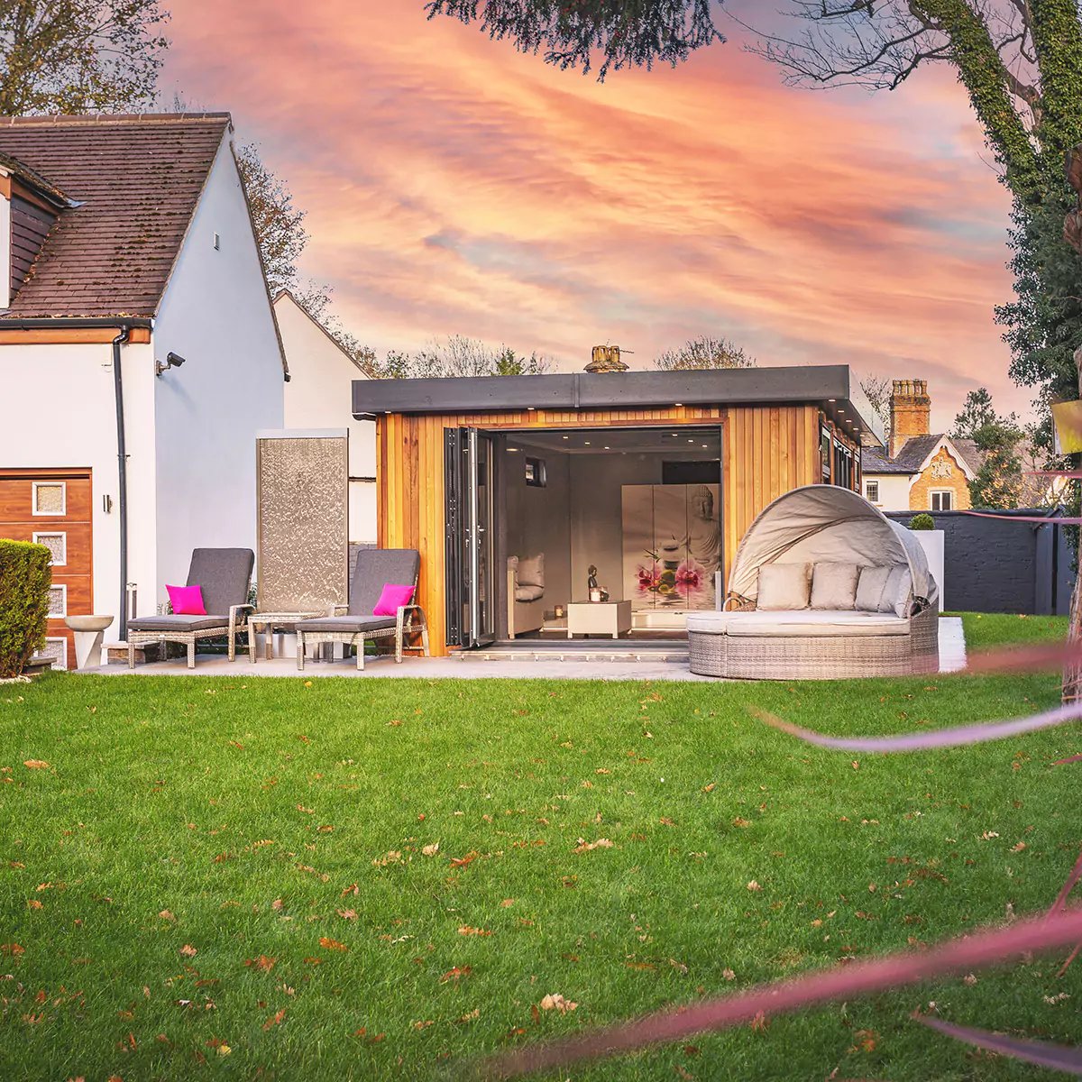 External shot of a summer house at dusk with beautiful pink sky