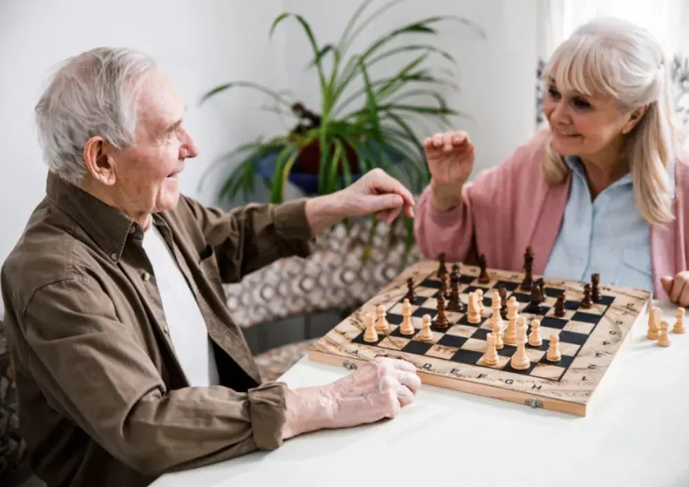 elderly people playing chess