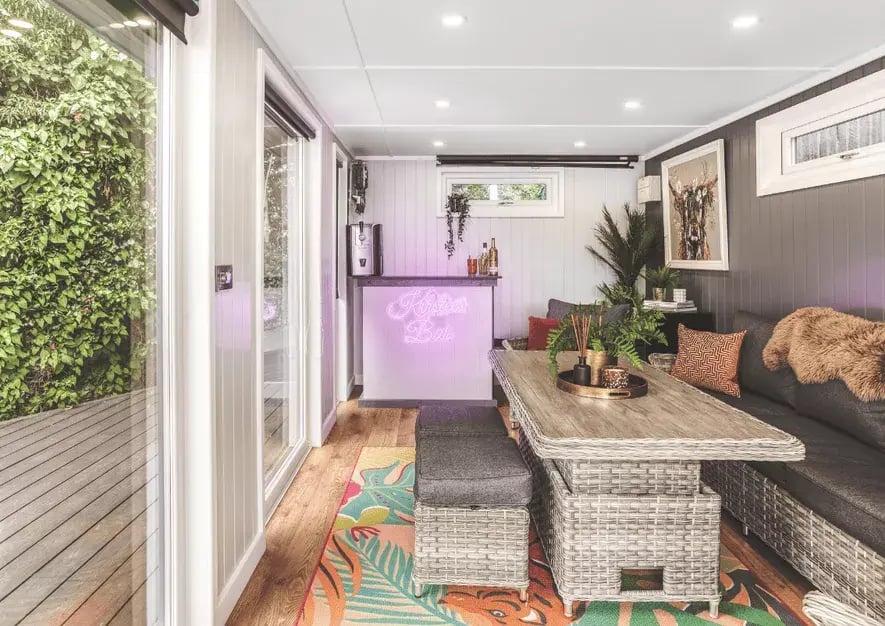 bar area with neon light inside a garden bar