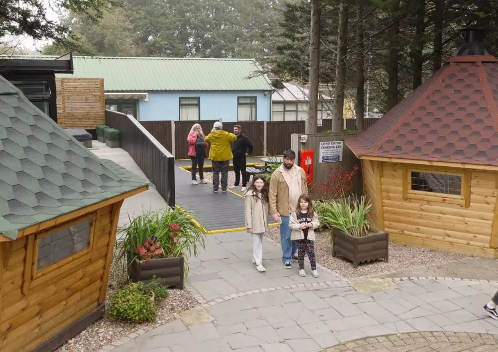 customer exploring garden rooms and bbq cabin at the cabin master show site nottingham