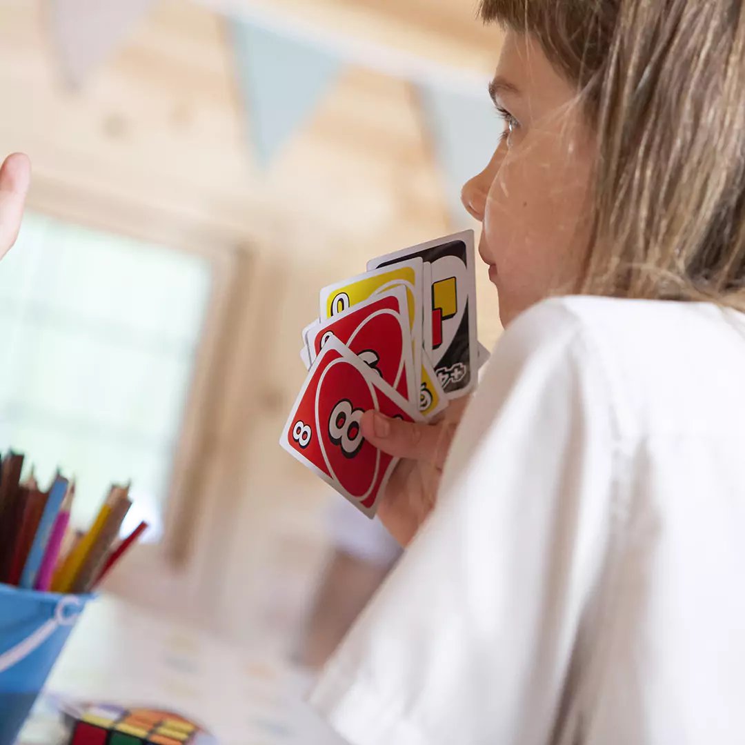 school pupils inside school cabin playing Uno