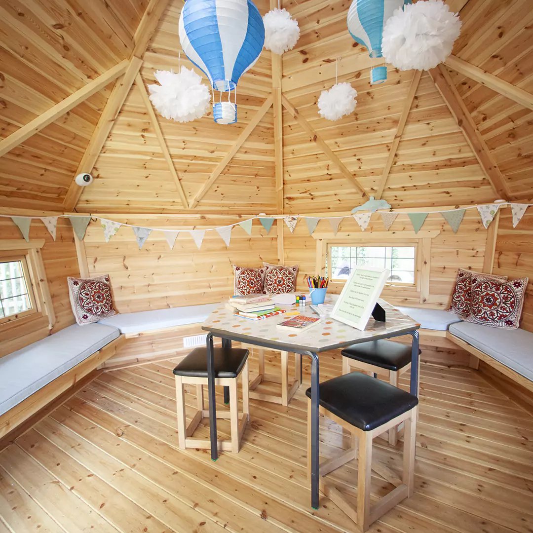 interior of a timber school cabin with desk set up