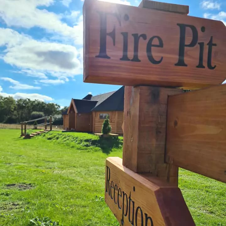 signposts for school near wooden cabin