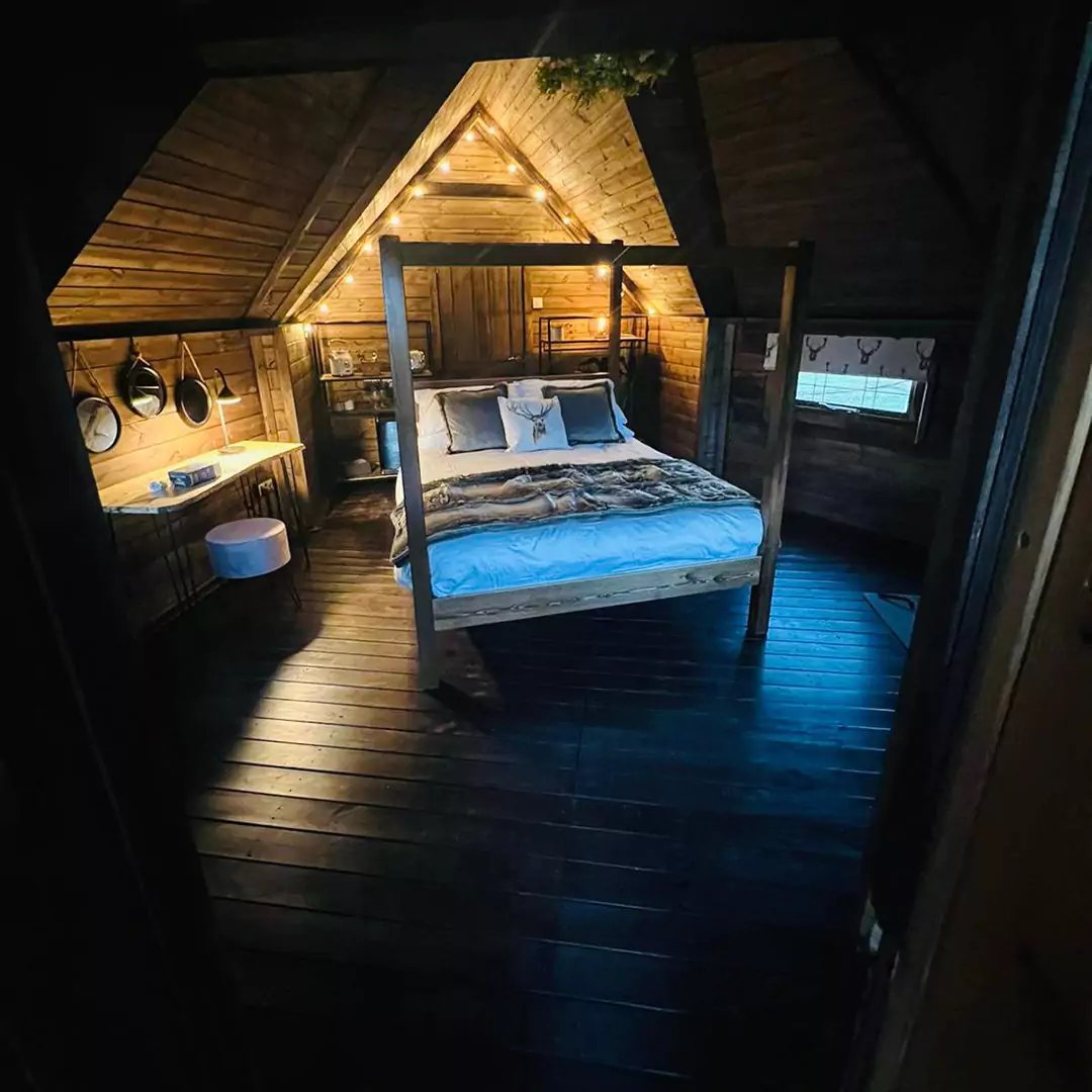 interior night time shot of a cabin bedroom with 4 poster bed