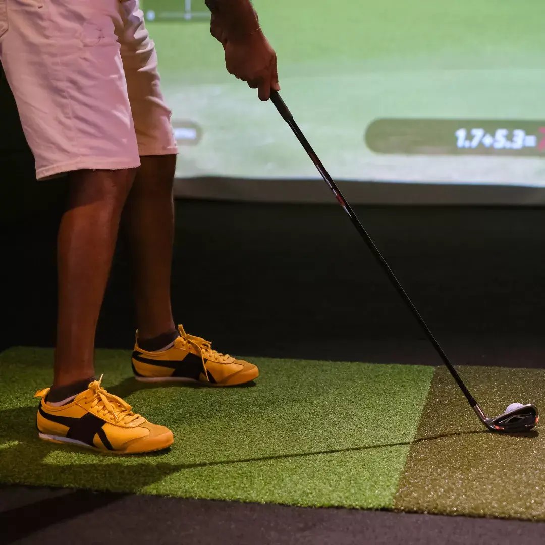 close up of golfer using indoor golf simulator