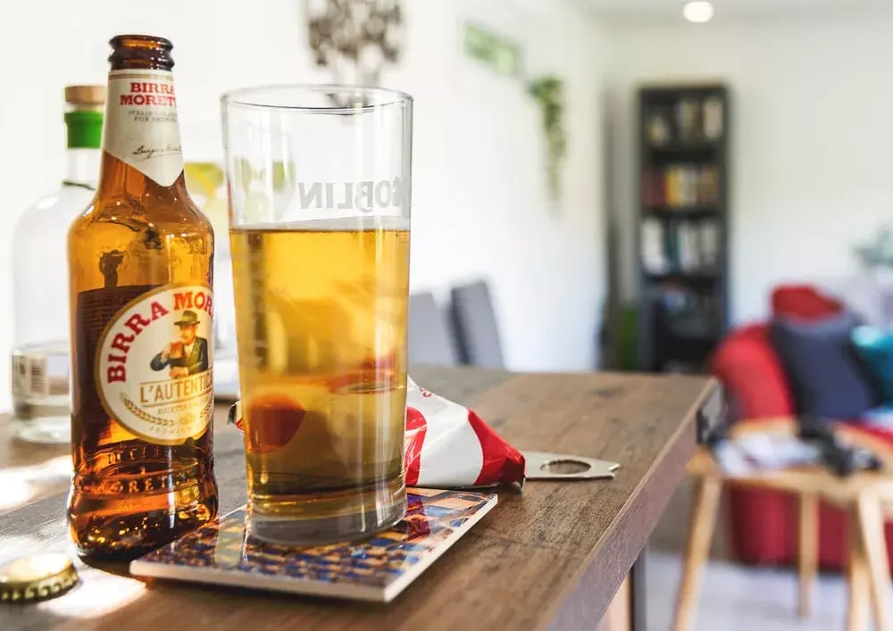 close up of beer bottles on bar inside a man cave for the garden