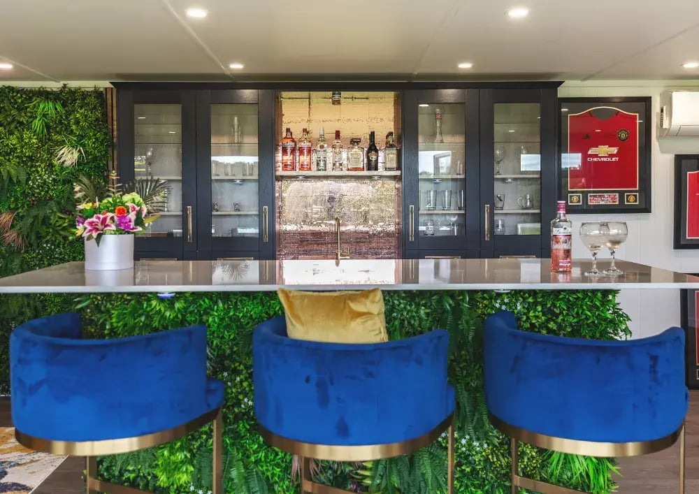 garden bar with blue seating and kitchen area