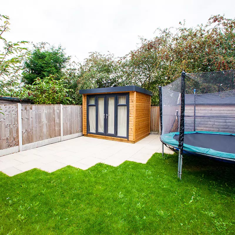 small garden music room with curtains closed on patio area with green lawn
