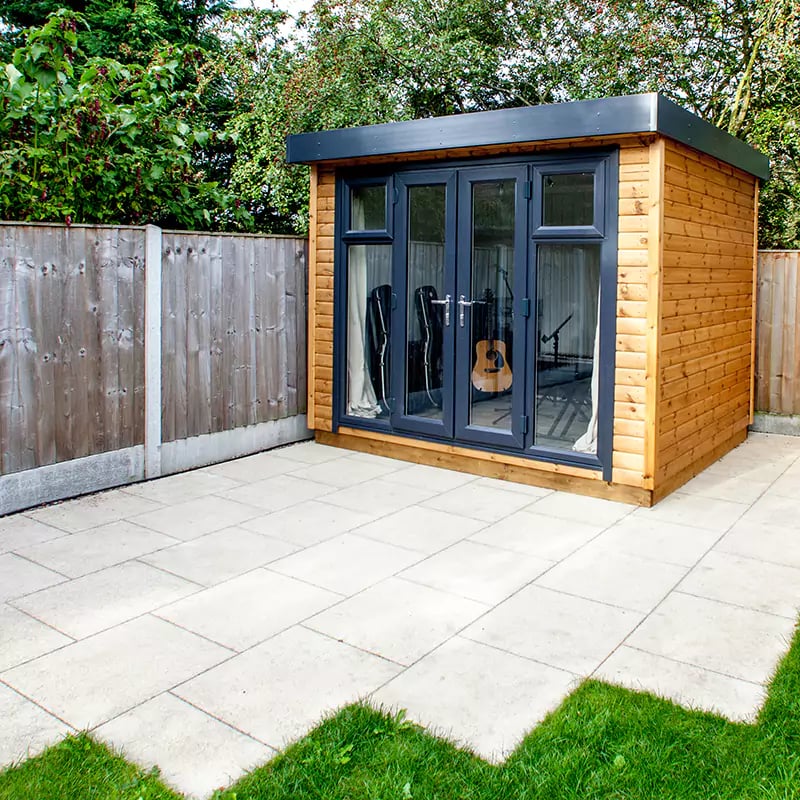 small garden music room with large open doors in patio area with guitar and microphone inside
