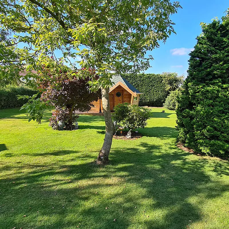 bbq cabin in large leafy garden