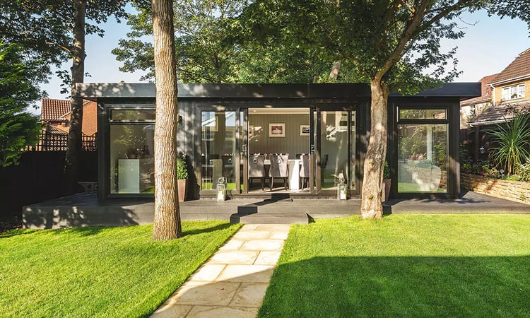 garden room with dining room set up inside in the garden 