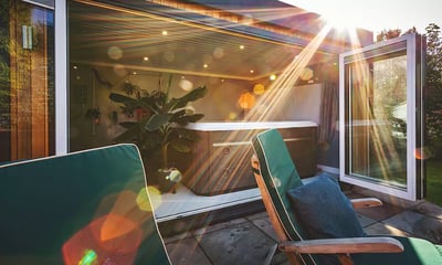 looking inside a garden spa room with a hot tub inside