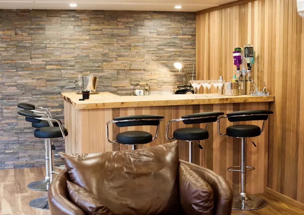 garden bar with slate feature wall and bar stools