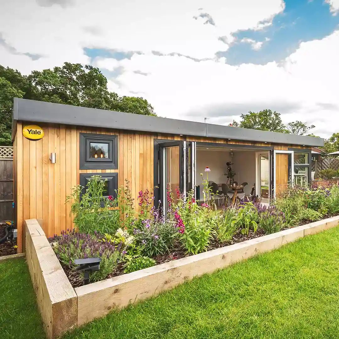 Building with open Bi-Fold Doors internal view with beers and crisps on the bar and view of the lawn area