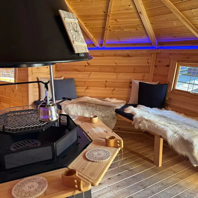close up of bbq area with tables inside an arctic cabin