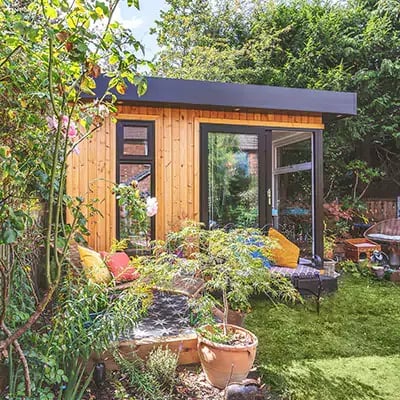 Small home office built in redwood with outdoor furniture and cushions