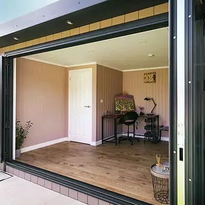 looking through bifold doors into garden oofice building