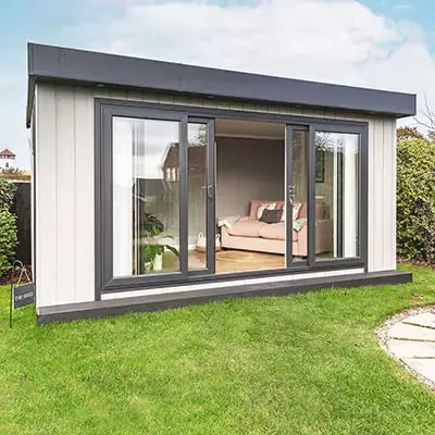 Zero maintenance outdoor office with bi-fold doors in neat garden with pond and pumpZero maintenance garden office with bi-fold doors in neat garden with pond and pump