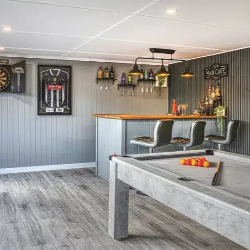inside a garden games room with pool table and dart board