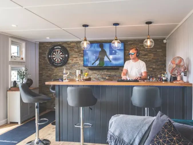 man djing inside garden bar