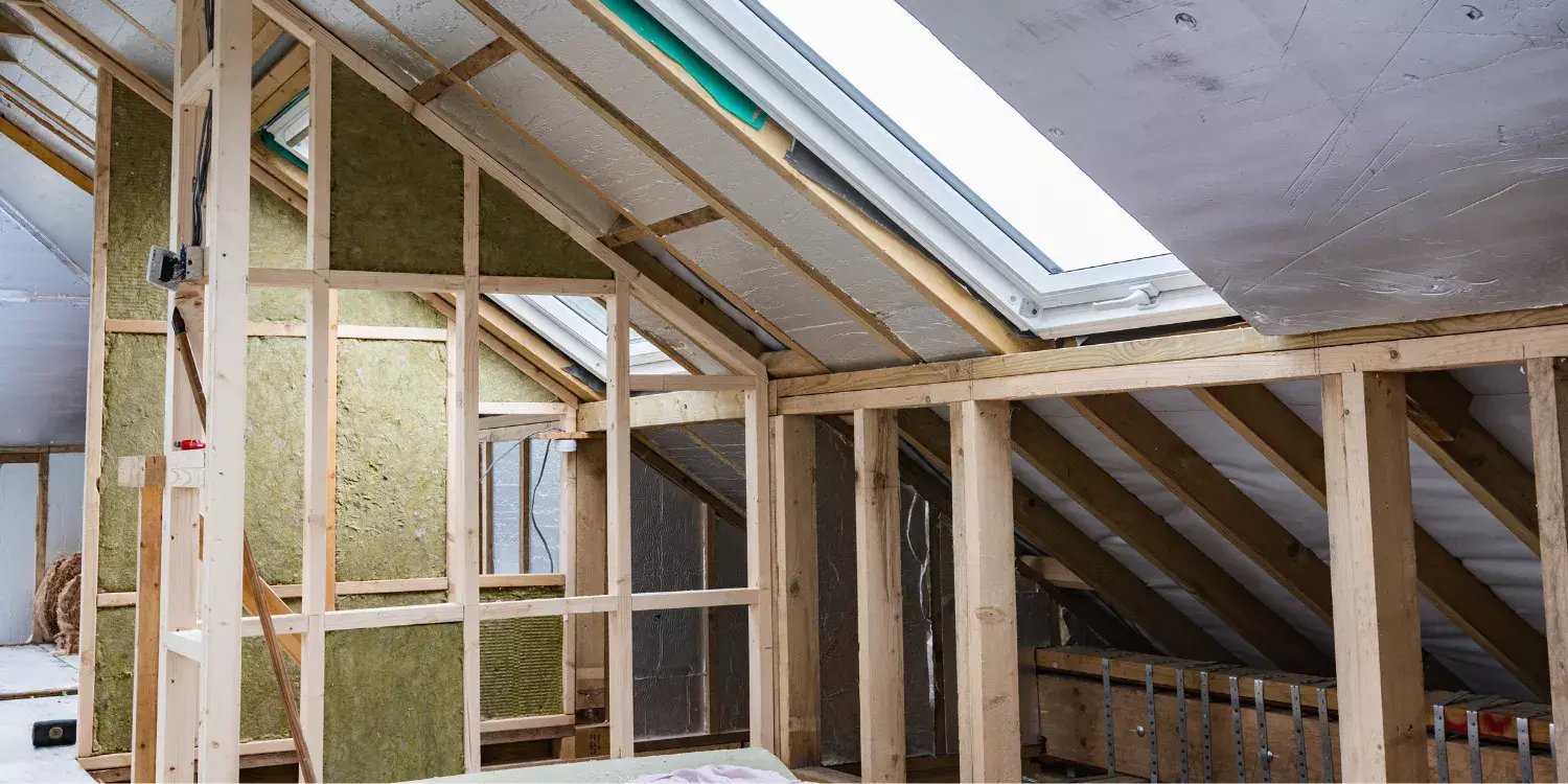 loft conversion in progress with timber frames and partial insulation