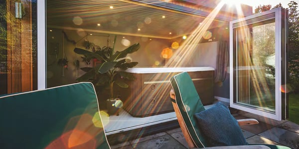 Shot looking into a garden room with hot tub on bright sunny day 