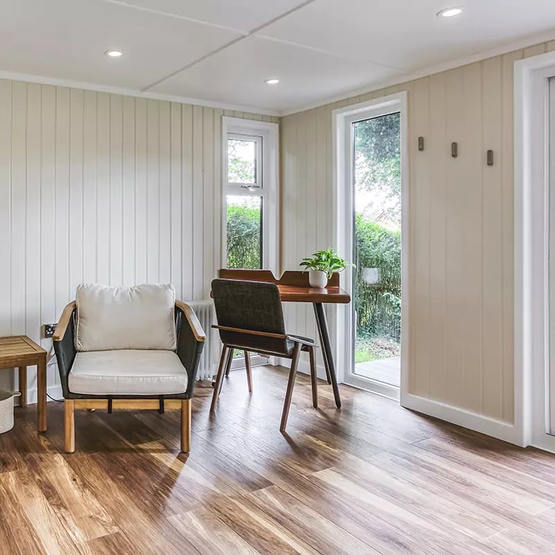 Interior of a chic calm garden office with desk & chair