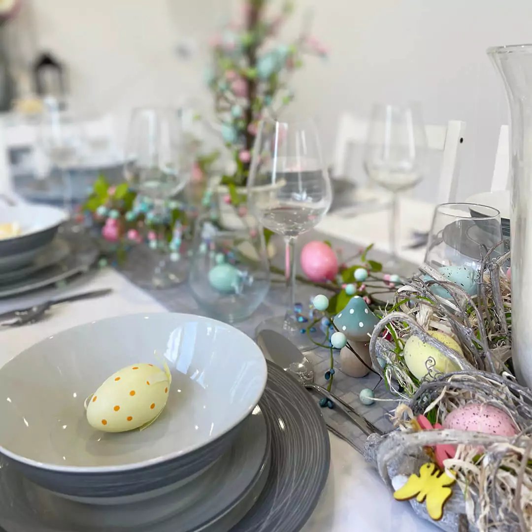 Inside view of Garden Dining Room with large white dining table and chairs and various easter decorations 