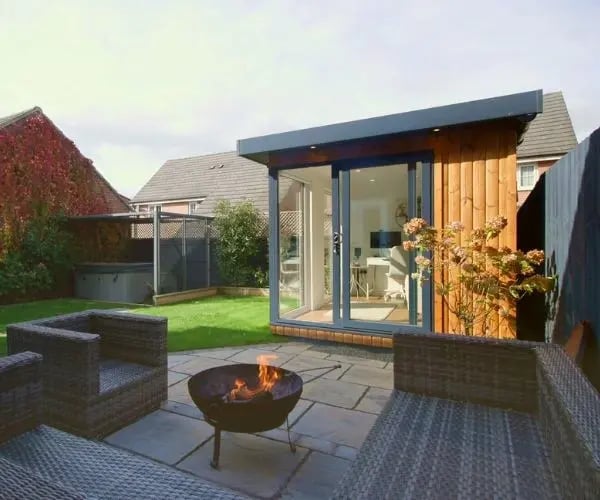 side view of a small garden office with sliding doors