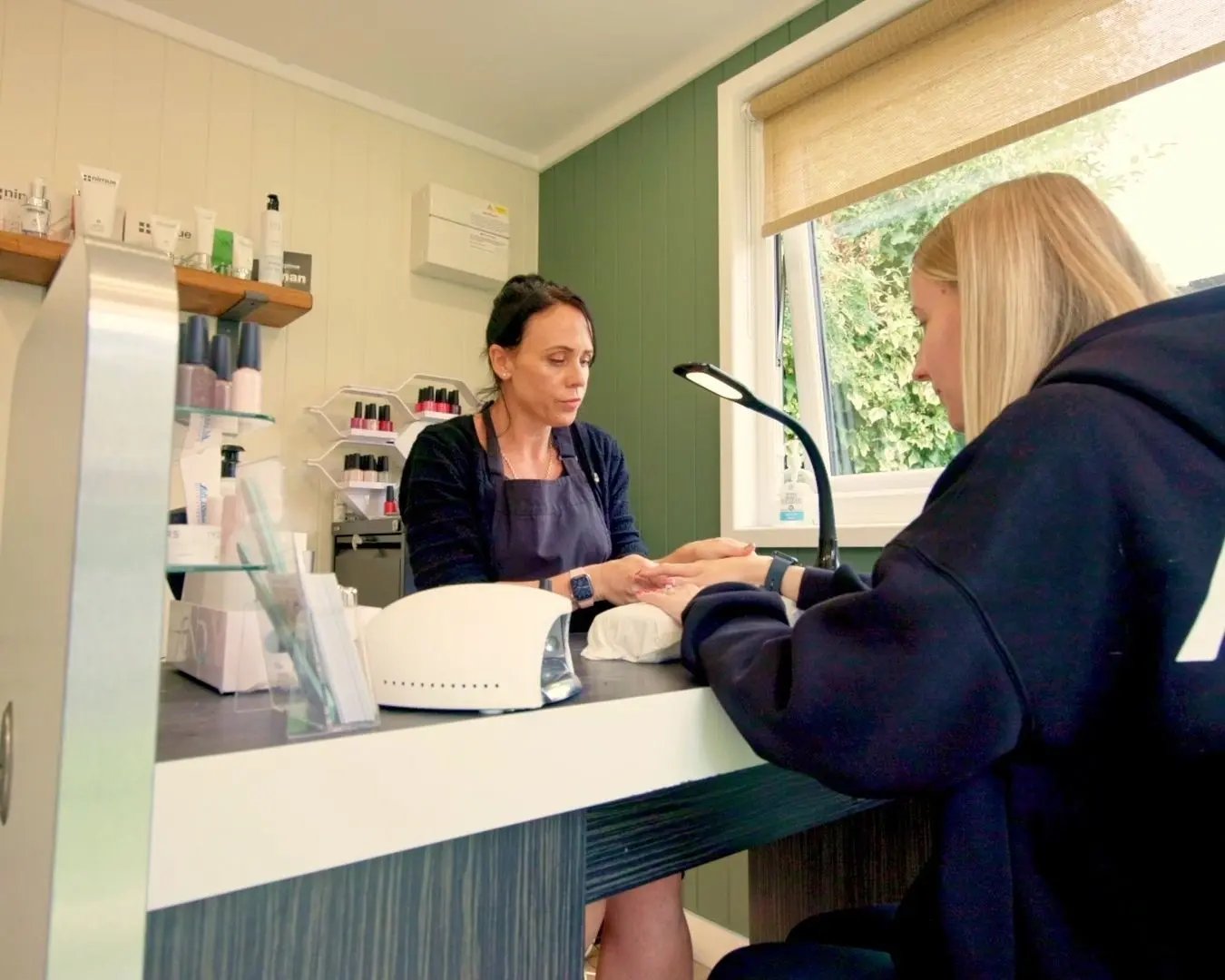 beauty client having nails done inside garden cabin