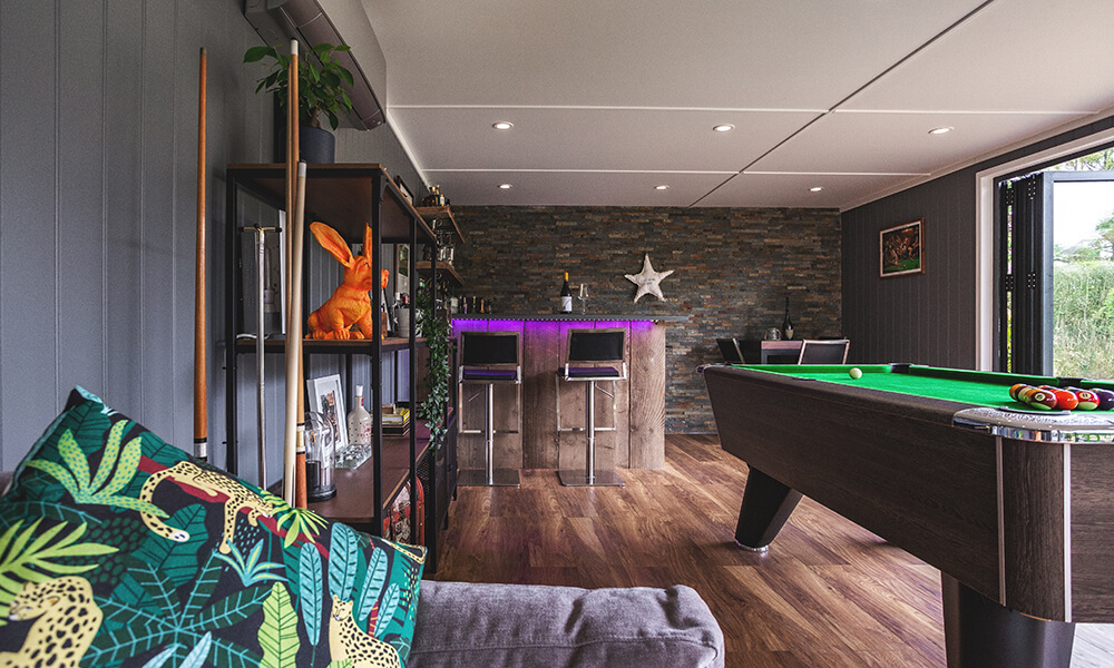 Interior of a garden bar man cave with pool table and bar