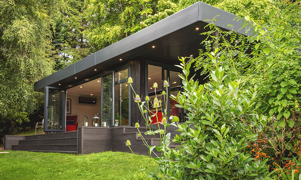 Large black zero maintenance garden room with veranda